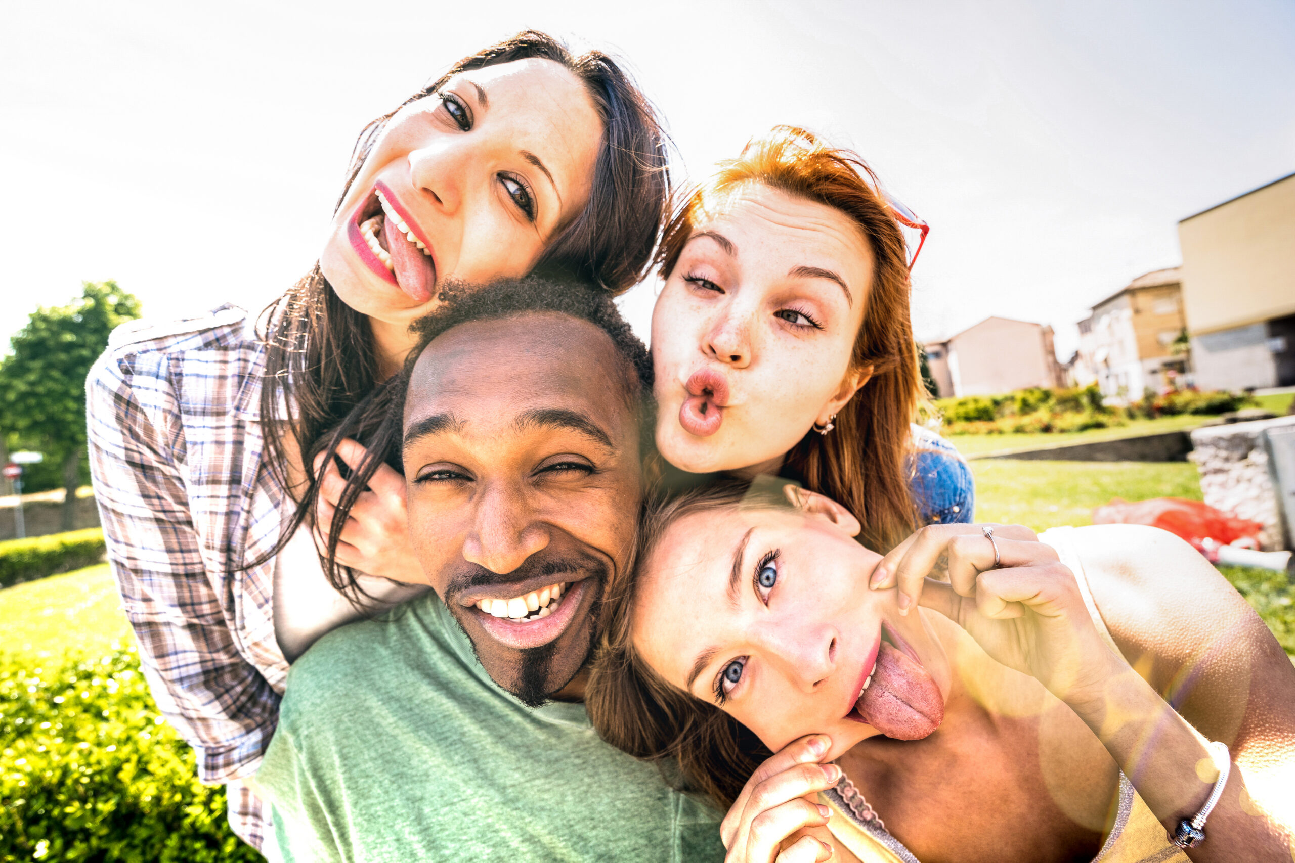 Happy multiracial friends group taking selfie sticking tongue out with funny faces - Young people sharing stories on social network community - Millennials lifestyle concept on vivid vintage filter